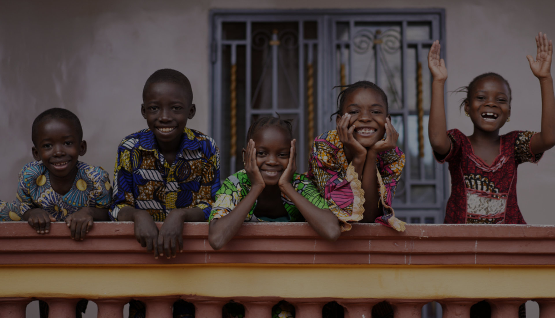 Children in rural Nigeria reading together outdoors